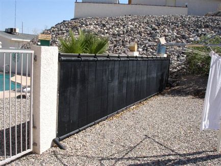Heliocol solar pool heating panels are easily installed on fences or ground mounts.