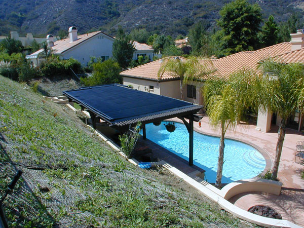 Heliocol solar pool heating panels installed on a patio roof.